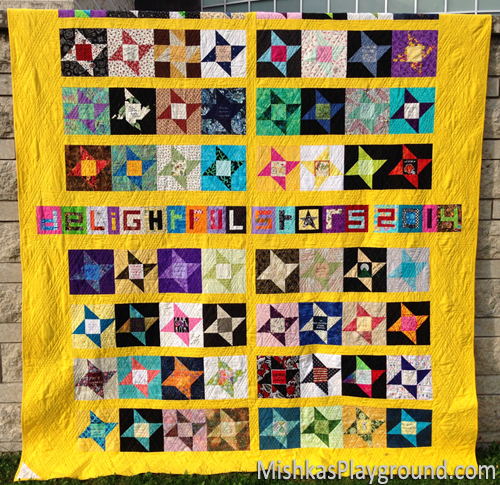 The back of my quilt includes friendship stars and paper pieced letters sent from quilters around the world.